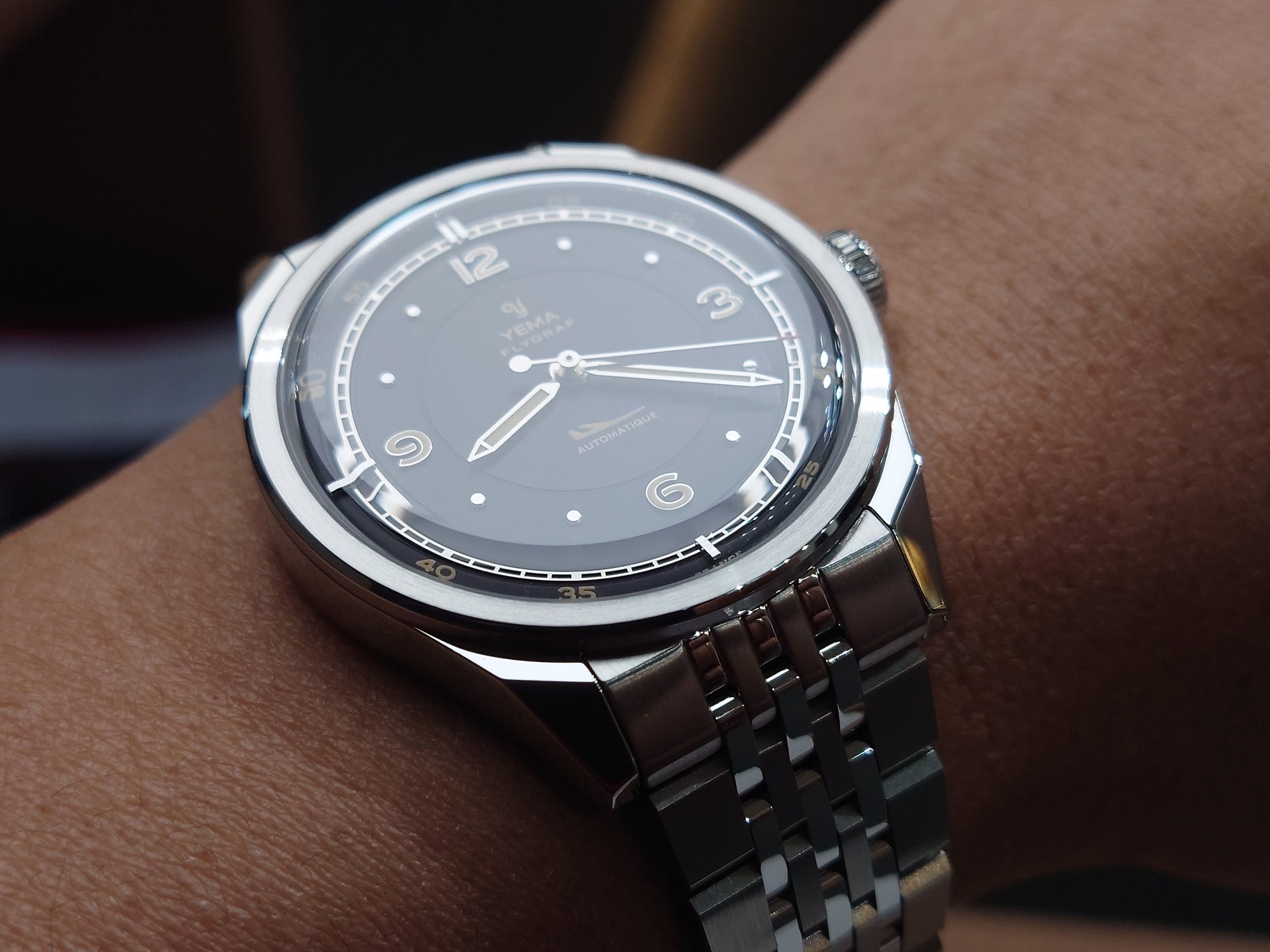 YEMA FLYGRAF Pilot automatic wristwatch with stainless steel bracelet and black dial display style shot.